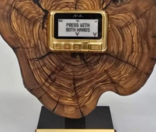 Netanyahu's gift to Trump: a gold pager on a wood plaque.