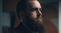 Close-up profile of a man with a beard.