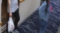 Security camera image of a man and woman in a hotel hallway.