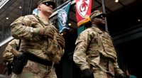 Two soldiers in camouflage uniforms stand in New Orleans.