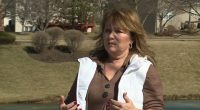 Woman speaking outdoors about HOA lawsuit.