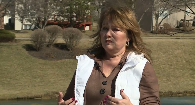 Woman speaking outdoors about HOA lawsuit.
