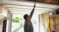 Man repairing a garage door.