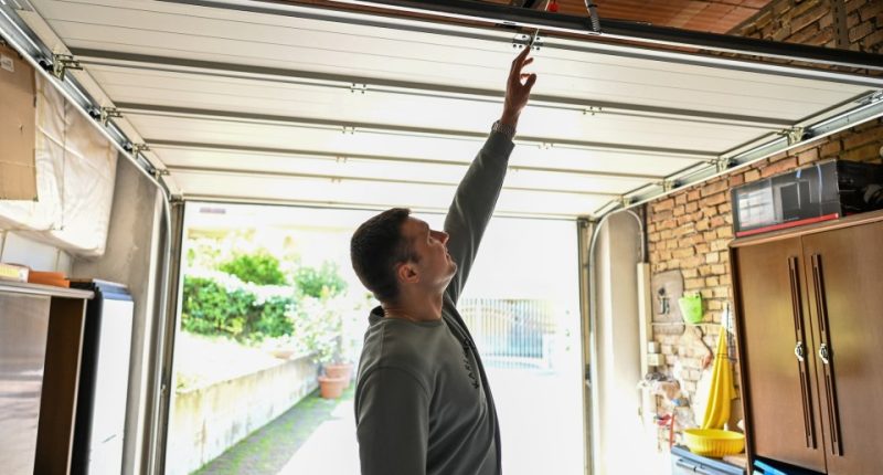 Man repairing a garage door.