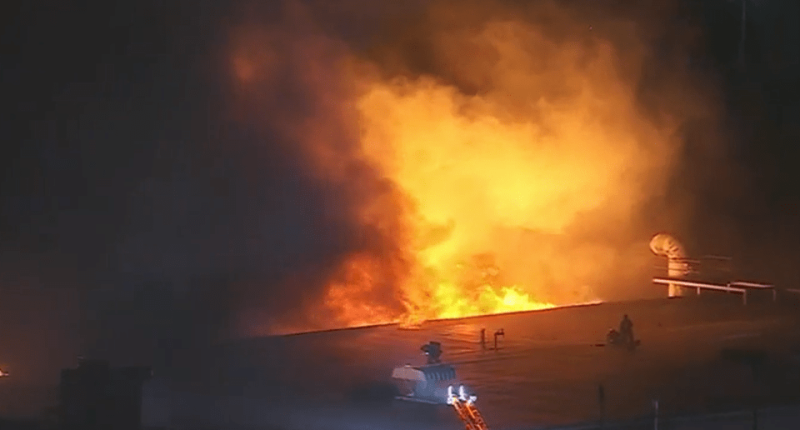 Warehouse engulfed in flames.