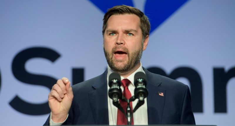 JD Vance speaking at a podium.