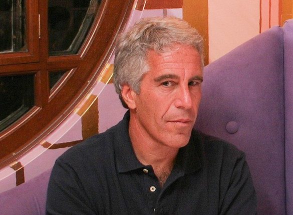 Photo of Jeffrey Epstein seated at a table.