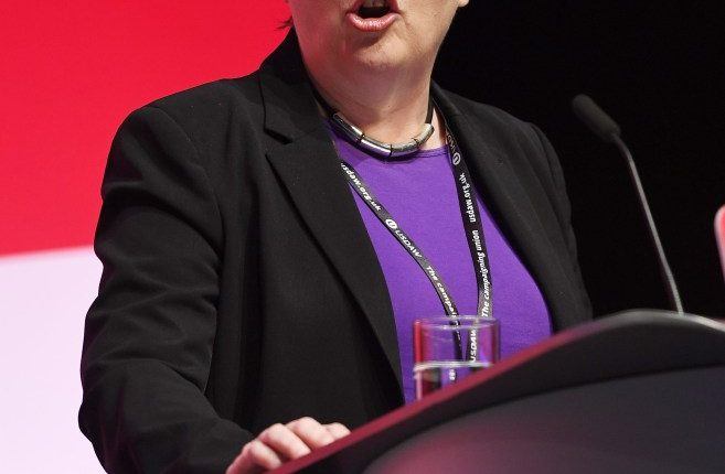 a woman is giving a speech at the labour party annual conference