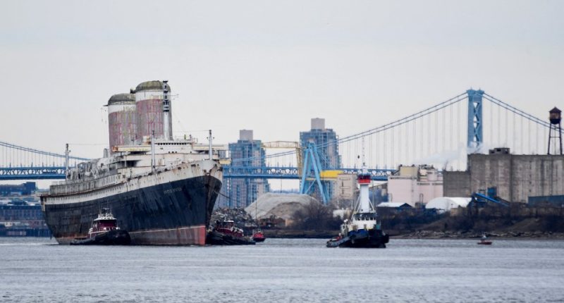 The SS United States being towed out to sea.