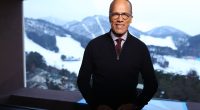 Lester Holt in front of a snowy mountain landscape.
