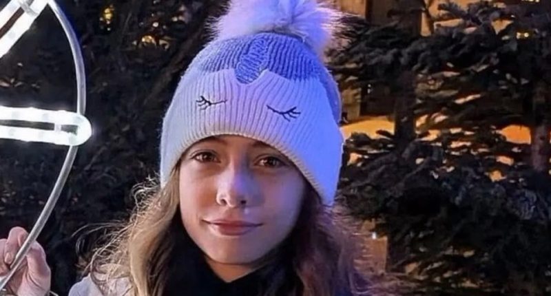 Girl wearing a unicorn hat.