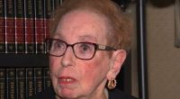 84-year-old woman discussing legislation to prevent fraudulent bank schemes.