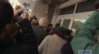 Crowd of people filming a man at the Department of Education.
