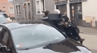 Police officers arresting a suspect on a city street.
