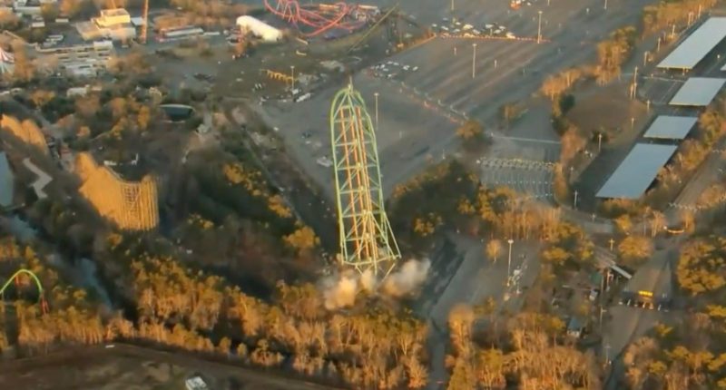 Aerial view of a tall roller coaster being demolished.