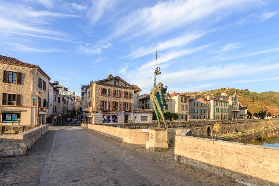 Sculpture on a stone bridge in Villefranche-de-Rouergue, France.
