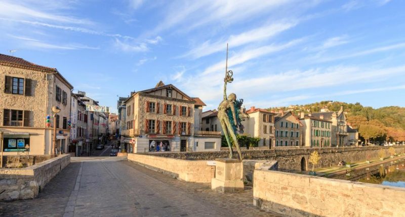 Sculpture on a stone bridge in Villefranche-de-Rouergue, France.