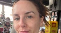 Close-up selfie of a woman outdoors.
