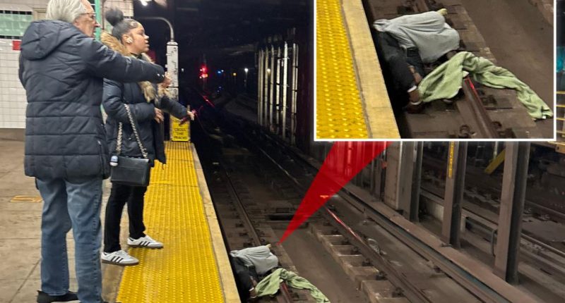 NYC straphangers flag down help for incoherent man lying on tracks -- moments before incoming train was due to arrive