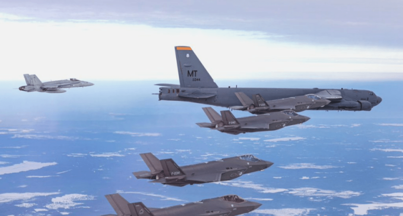 Formation of military aircraft in flight.