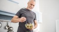 mature older man eating salad