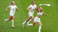 Three England women's soccer players celebrating a goal.