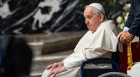 Pope Francis in a wheelchair.