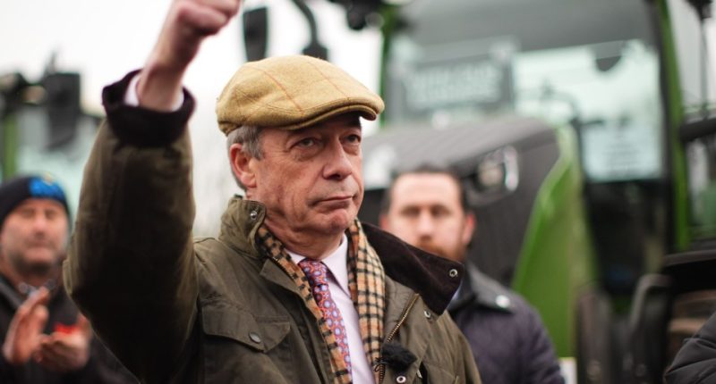 Nigel Farage giving a thumbs-up while speaking into a microphone.