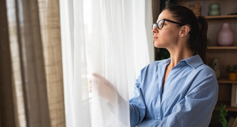Woman looking out window.