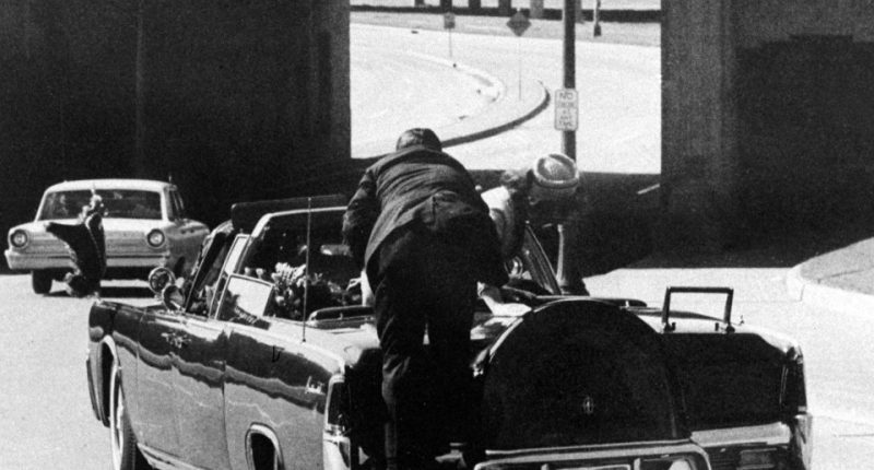 President John F. Kennedy slumped in the back of a limousine after being shot.