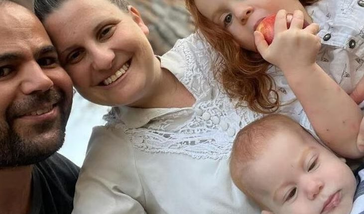 Family portrait of a couple with their two young children.