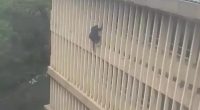 Man escaping from a courthouse window.
