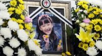 Framed photo of a smiling girl surrounded by flowers.