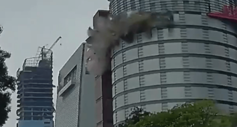 Debris falling from a building, creating smoke.