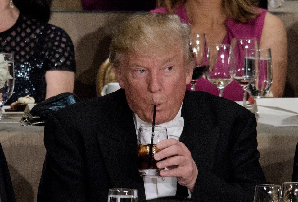 Donald Trump drinking from a glass with a straw at the Alfred E. Smith Memorial Foundation Dinner.