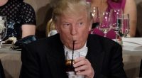 Donald Trump drinking from a glass with a straw at the Alfred E. Smith Memorial Foundation Dinner.