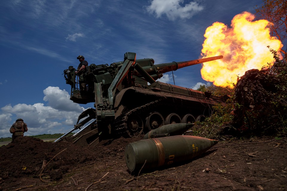 Ukrainian soldiers firing a self-propelled howitzer.