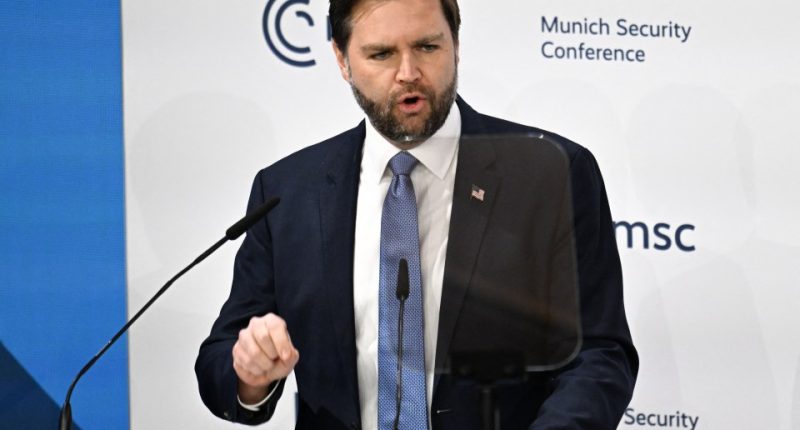 Man in suit speaking at a podium at the Munich Security Conference.