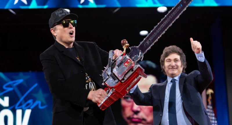 Elon Musk holding a chainsaw at CPAC.