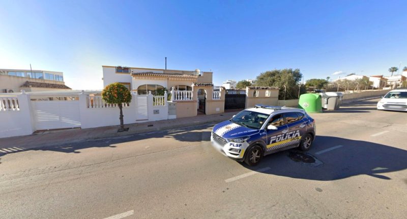 A police car parked outside a house in San Fulgencio, Spain.