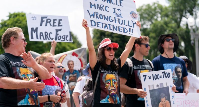 Protestors holding signs advocating for the release of Marc Fogel.