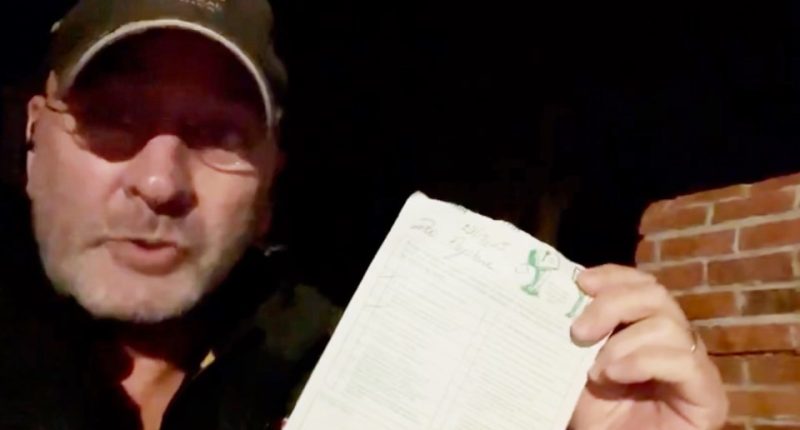 Man holding a USPS delivery slip.