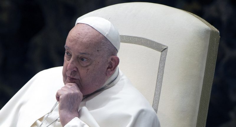 Pope Francis seated, hand to chin.