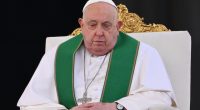 Pope Francis seated in a chair.