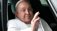 Pope Francis waving from a car.