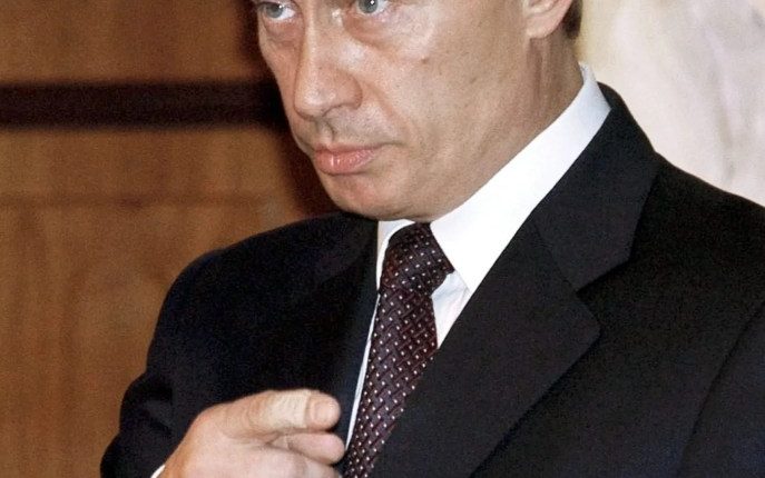 Vladimir Putin gesturing during a meeting.