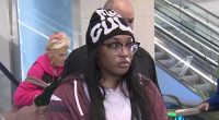 Woman on escalator, allegedly scammed out of life savings.