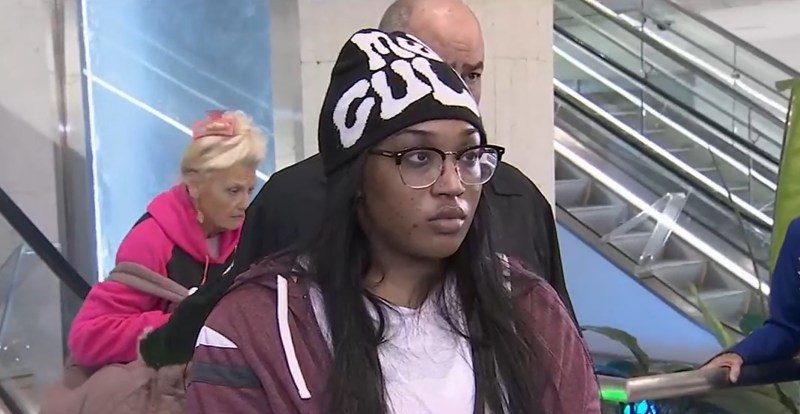 Woman on escalator, allegedly scammed out of life savings.