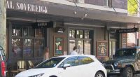 A military veteran regrets photographing his mate unfurling a flag with a Nazi swastika only a stone's throw from a Jewish museum, saying he's no antisemite.