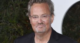 Matthew Perry in front of a step and repeat at an event.